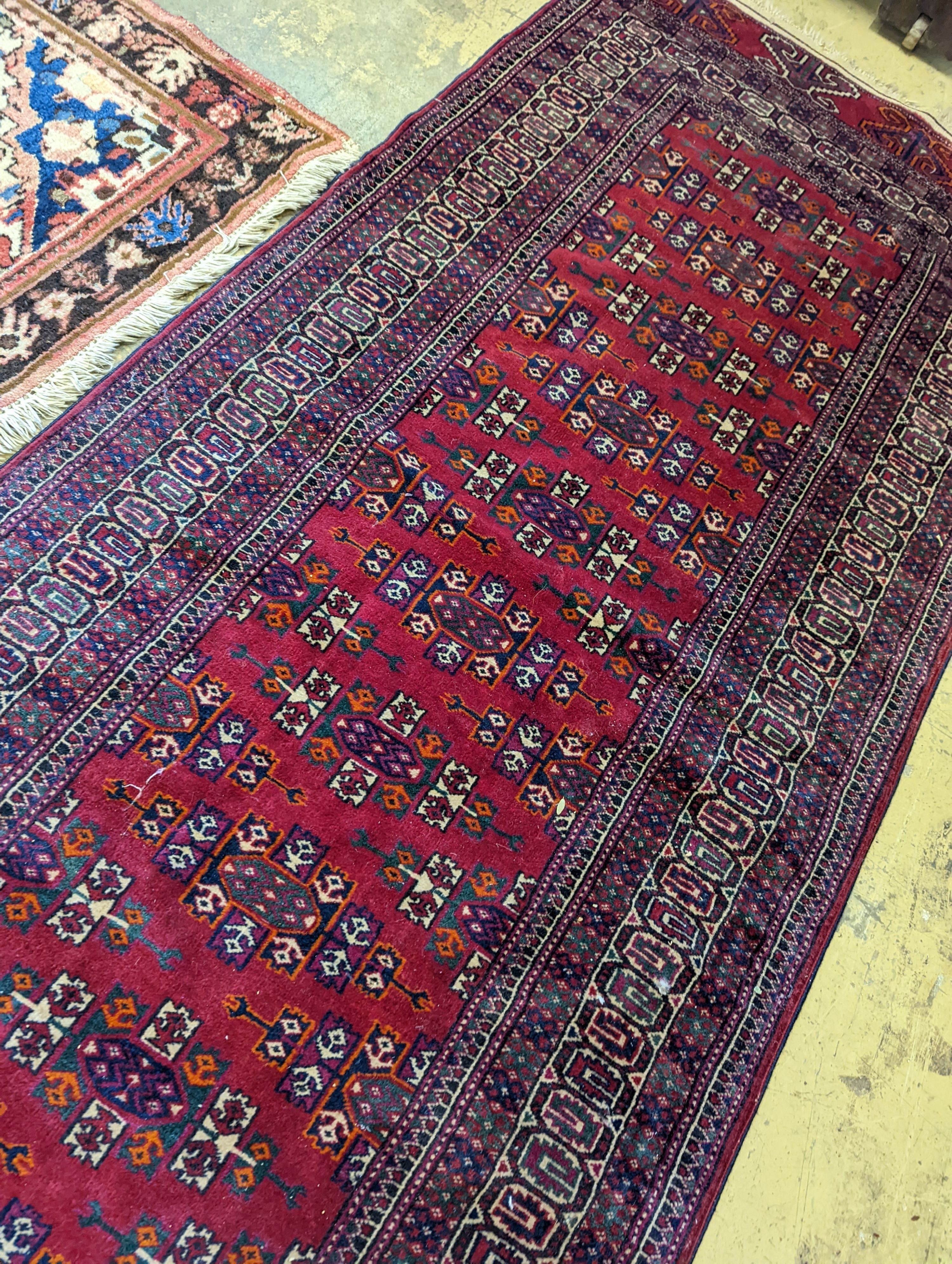 A Bokhara burgundy ground runner, 276 x 88cm